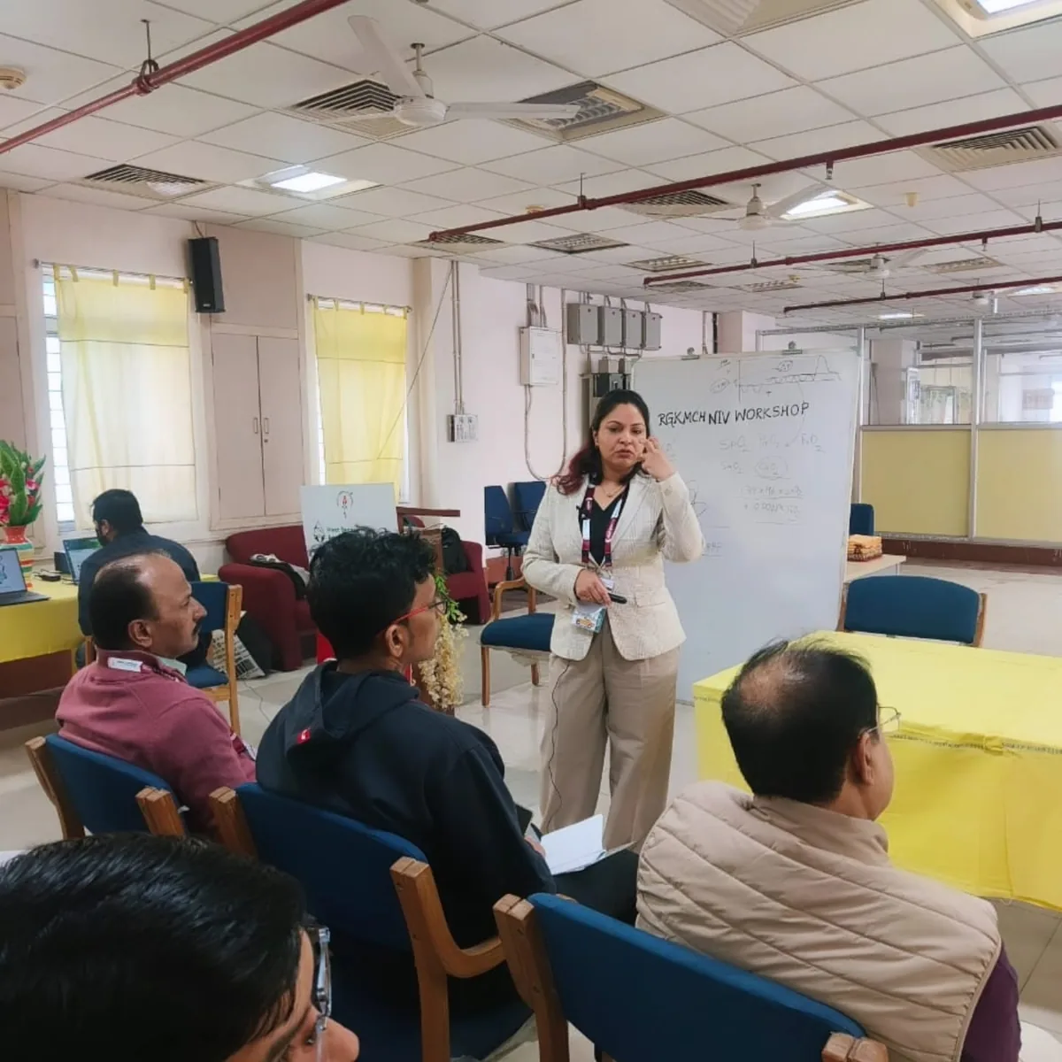 Dr. Swathi Rao teaching at a whiteboard during a non-invasive ventilation workshop