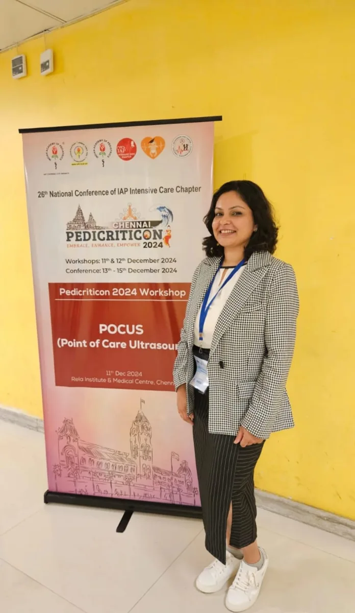 Dr. Swathi Rao beside the POCUS workshop banner at Pedicriticon 2024