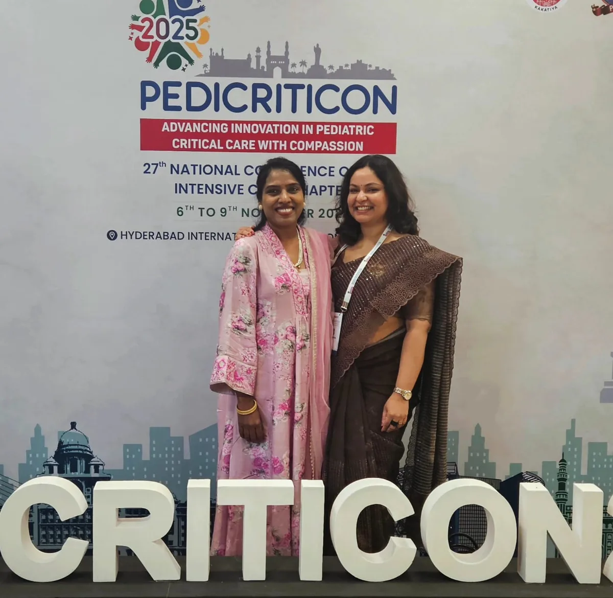 Dr. Swathi Rao with a colleague at the Pedicriticon 2025 backdrop