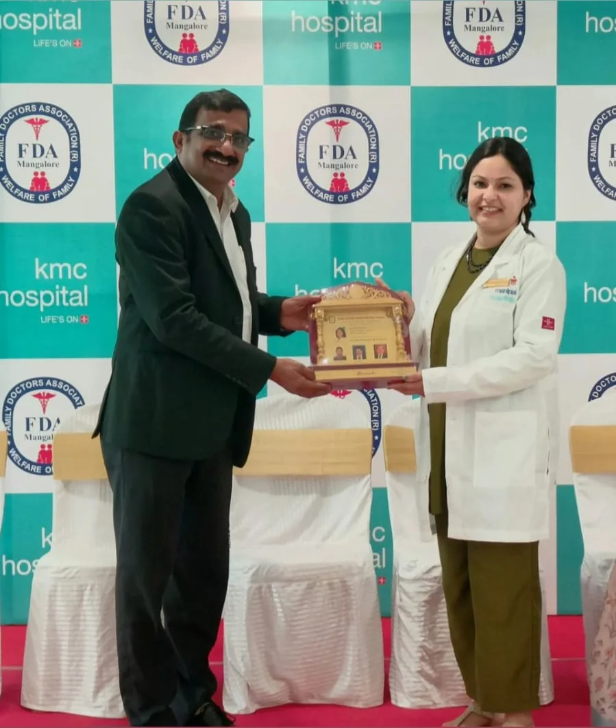 Dr. Swathi Rao receiving a memento at a KMC Hospital event