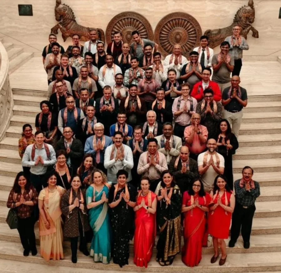 Large delegate group photograph on the steps of a conference venue